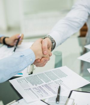 reliable handshake business partners after signing new contract in the workplace in the office.the photo has a empty space for your text